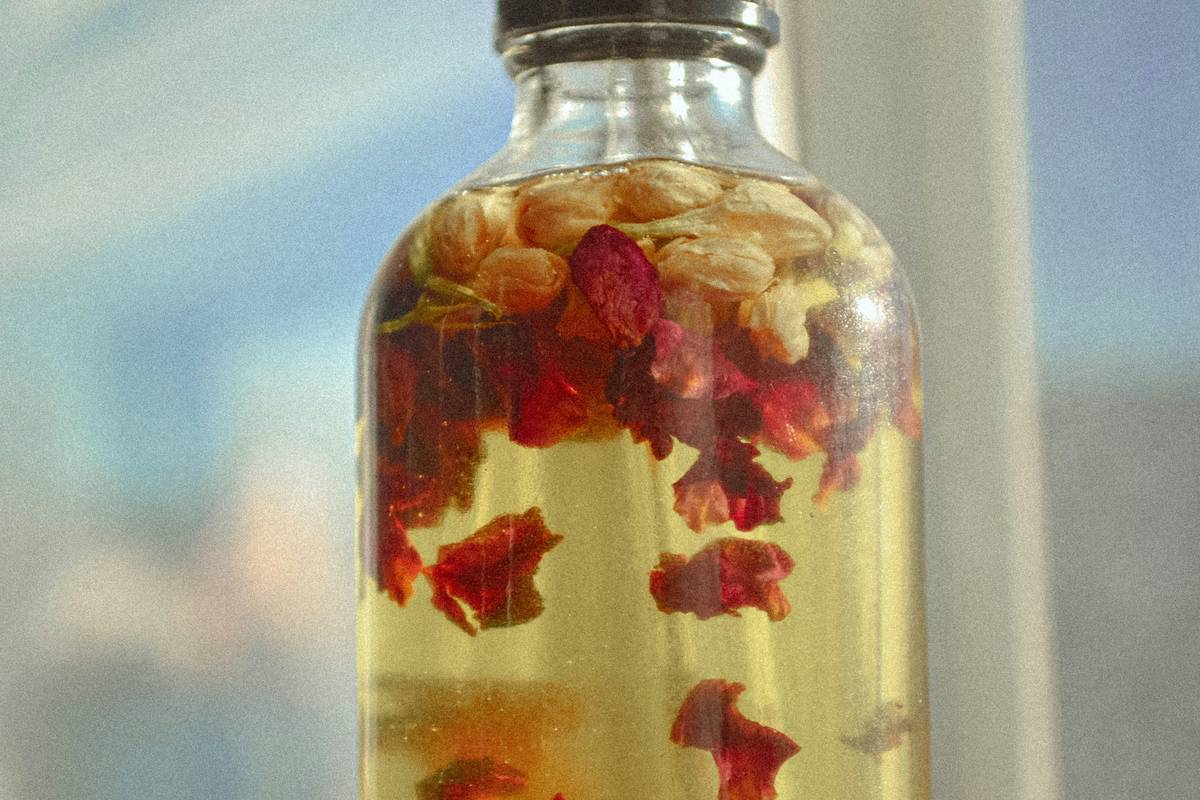 Bath essential scented oil perfect c in amber glass dropper bottle next to Epsom salts and a cotton washcloth